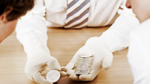 A person holding a stack of rare coins in ithaca new york.