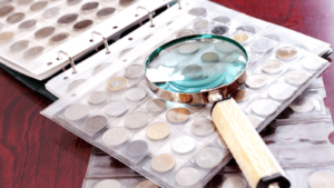 magnifying glass sits on top of coin collection at chris young coins in ithaca